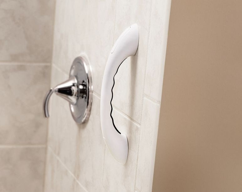 White curved bathroom grab bar with finger grooves for safety and balance in bath and accessibility collections