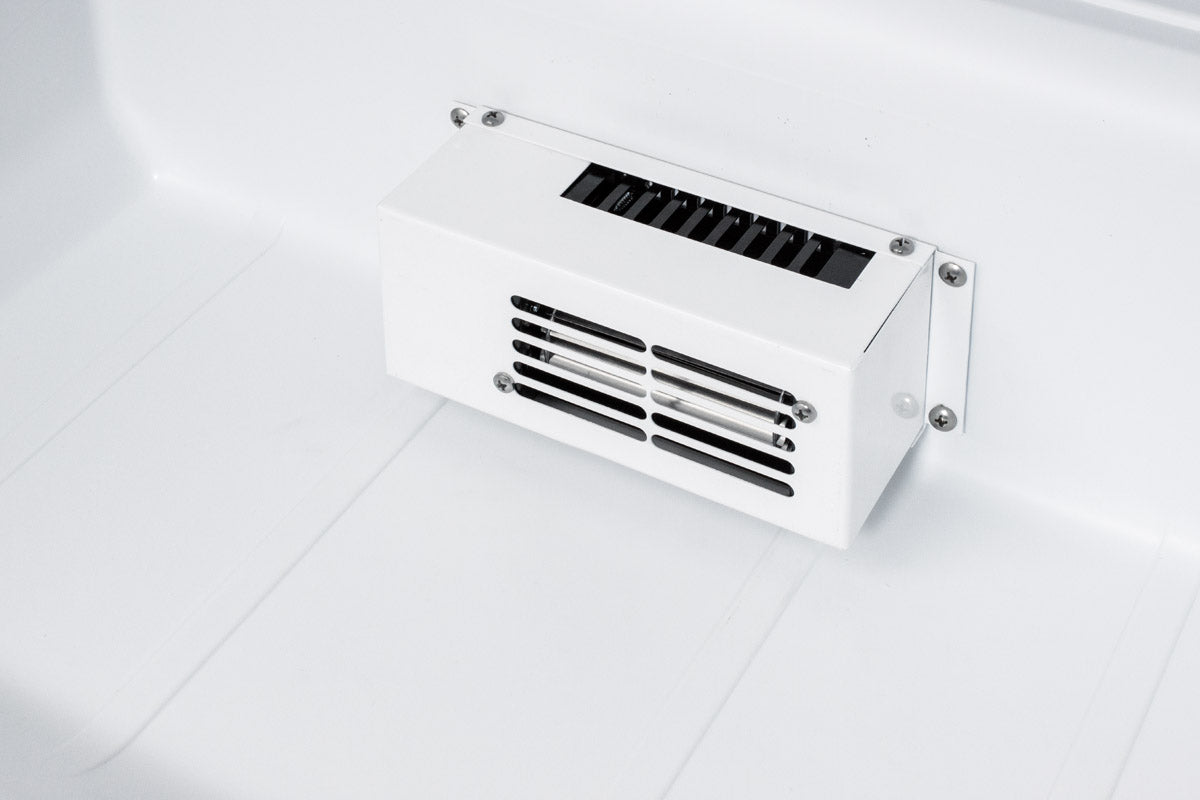 White vent panel with black slats inside a 24" wide built-in all-refrigerator for medical storage applications