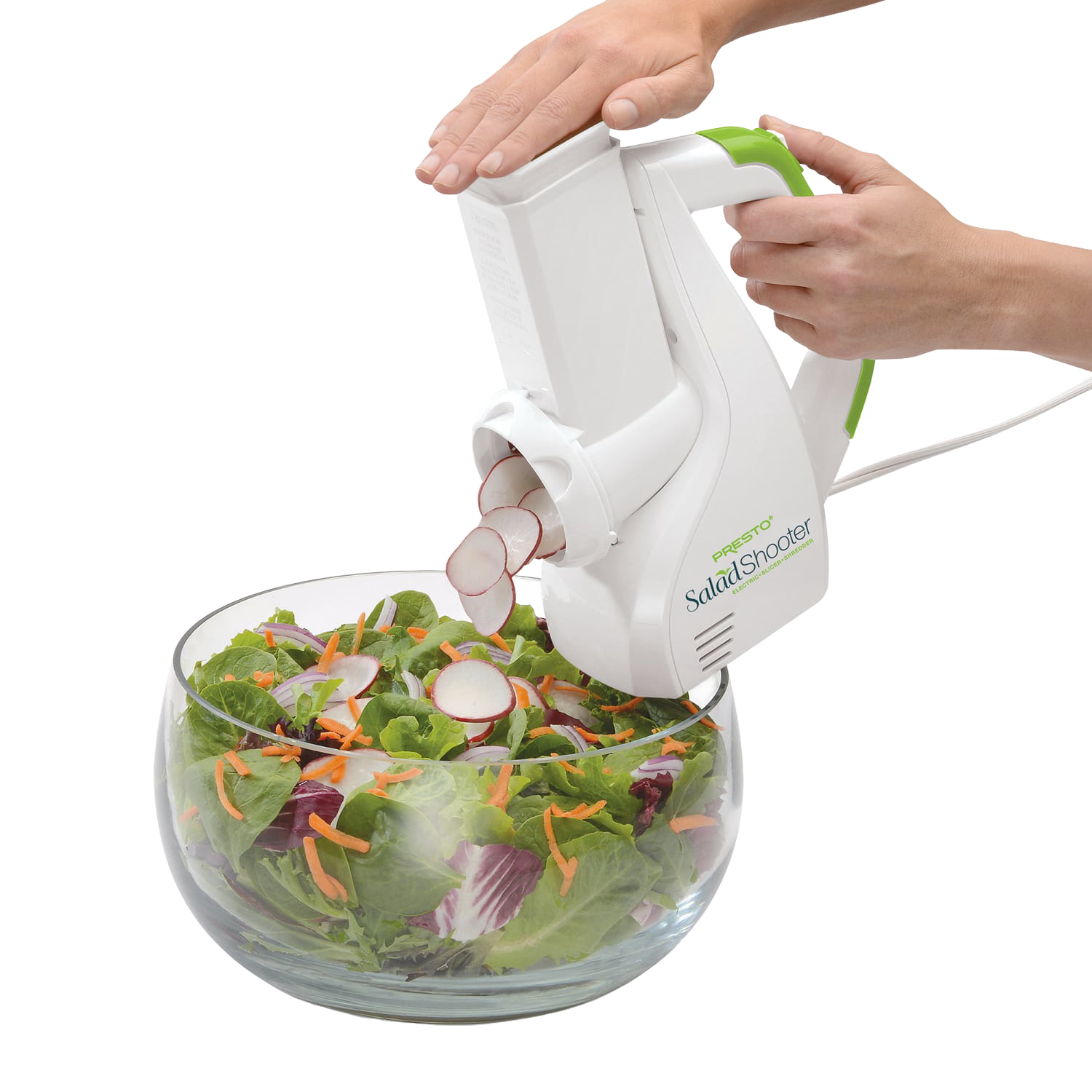 White and green electric slicer shredding radishes into a glass bowl with mixed salad in kitchen gadgets collections