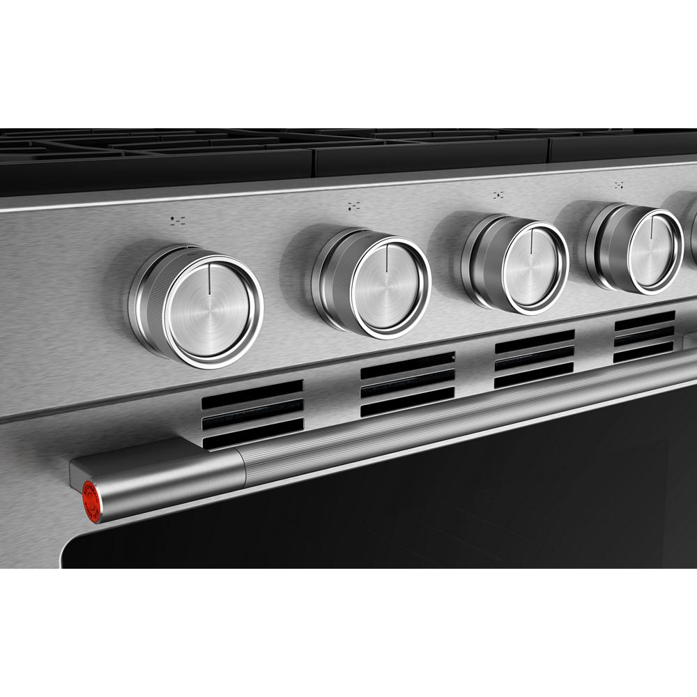 Close-up angled view of stainless steel control knobs on a smart freestanding gas range, highlighting modern design and precision controls for gas ranges and kitchenware collections.