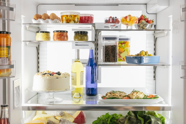 Open interior of stainless steel French door refrigerator featuring organized shelves with food and beverages in Kitchen & Kitchenware collections
