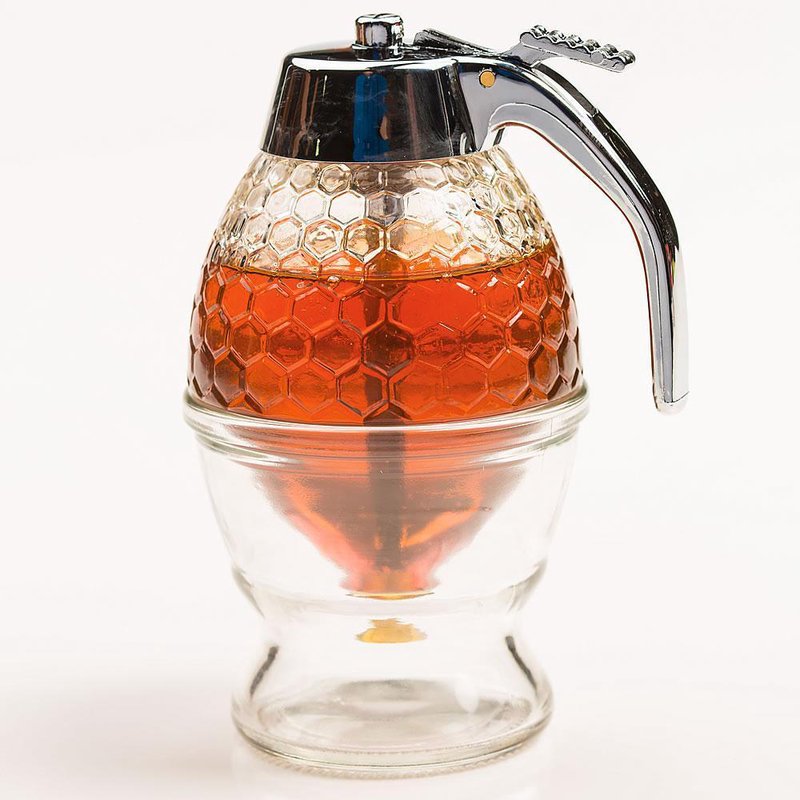 Glass syrup dispenser with honeycomb pattern and metal handle for easy pouring in kitchenware and storage collections
