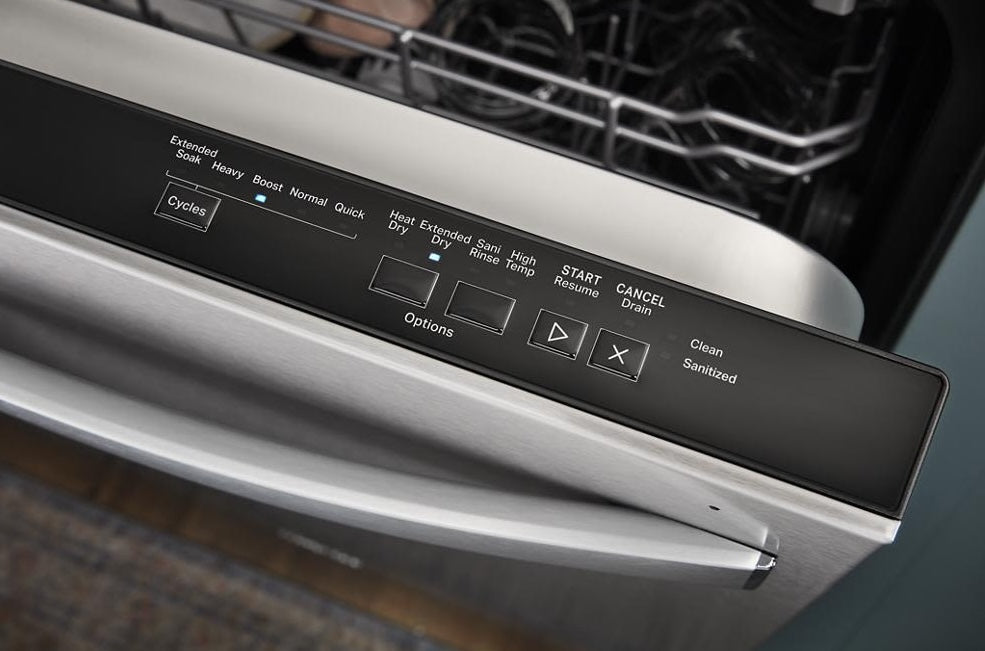 Close-up of stainless steel dishwasher control panel showing cycle options and buttons in kitchen appliance collection