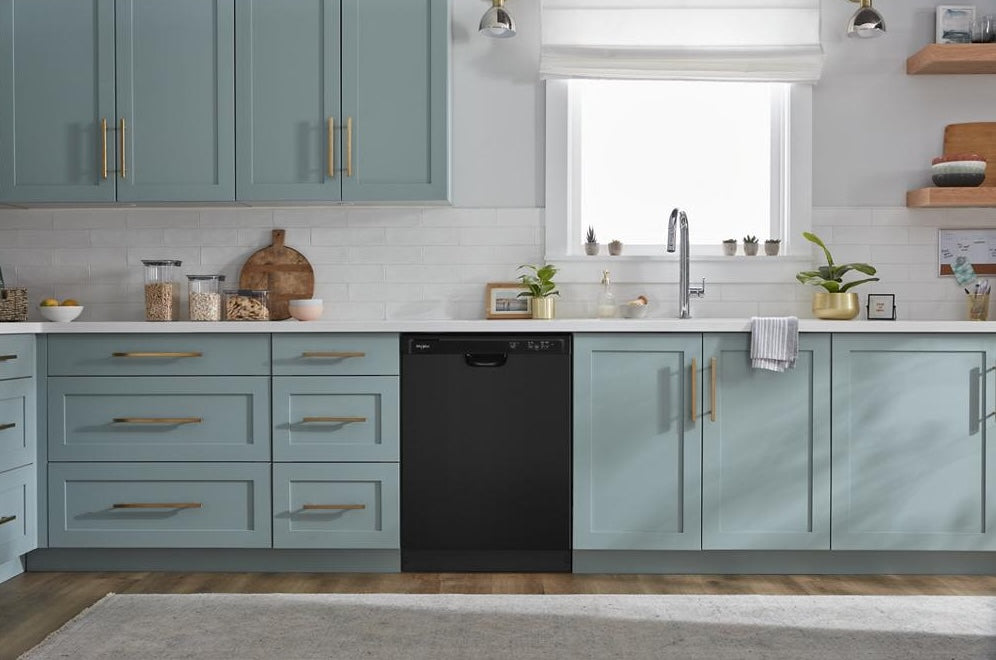 Modern kitchen with light blue cabinetry and a sleek black dishwasher integrated among storage drawers and sink area