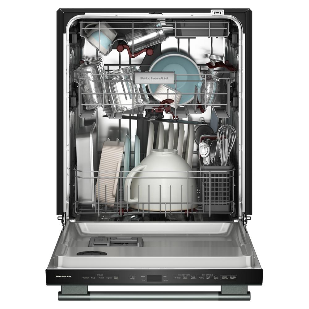 Open kitchenAid dishwasher loaded with clean dishes including bowls, plates, glasses, and utensils in a stainless interior.