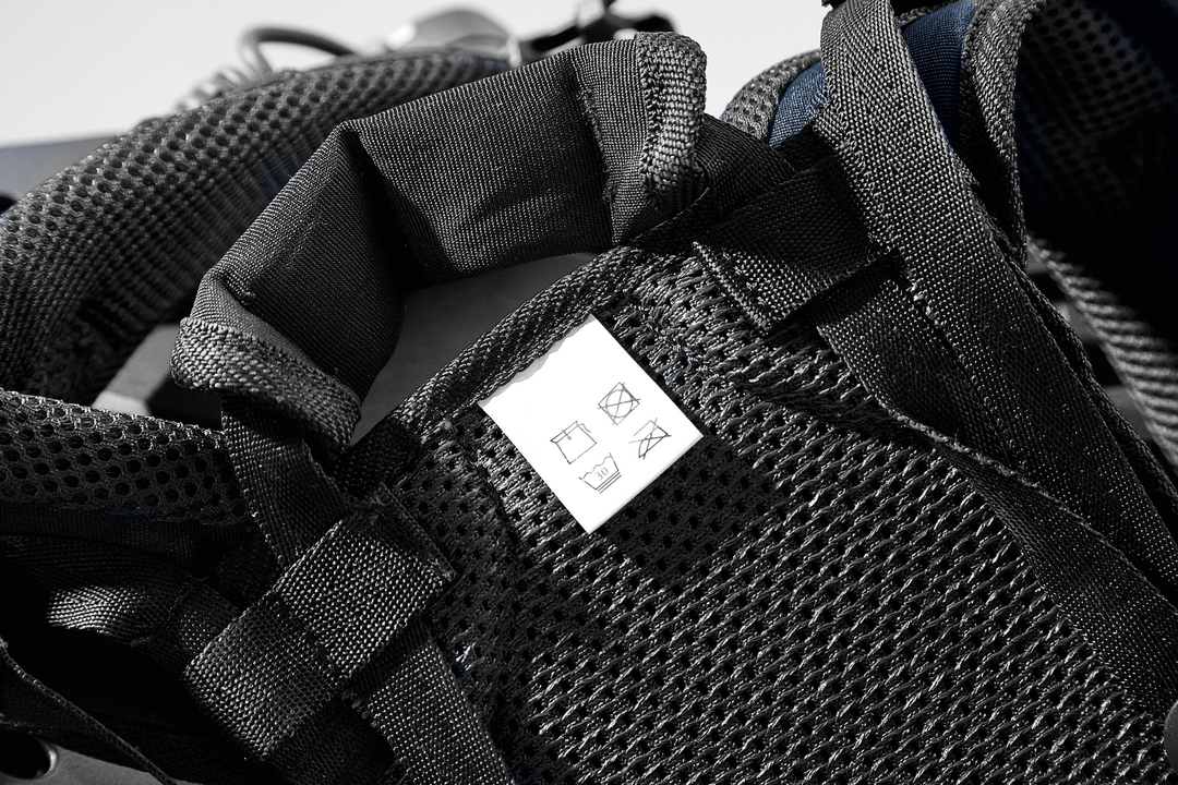 Close-up of black breathable mesh padding and adjustable straps with care label on a support harness in power tool accessories collection