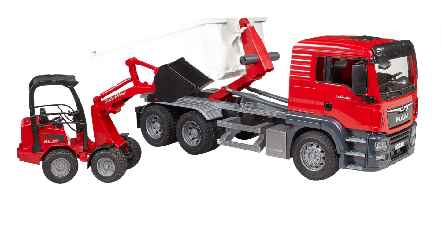 Red MAN TGS truck with tilting roll-off container and matching compact loader for construction and home improvement play