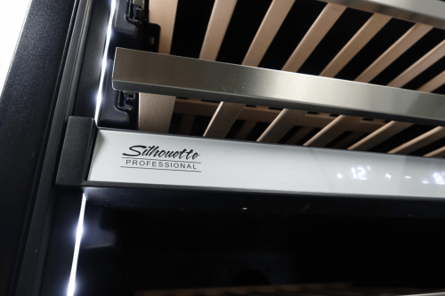 Close-up of stainless steel handle and digital temperature control on under-counter wine cellar in kitchen appliances collection
