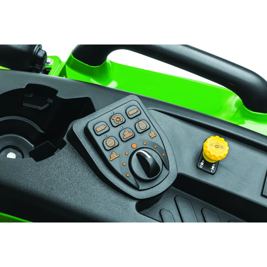 Close-up view of control panel with multifunction dial and yellow knob on green compact tractor featured in Outdoor Power Equipment at Hartville Hardware.