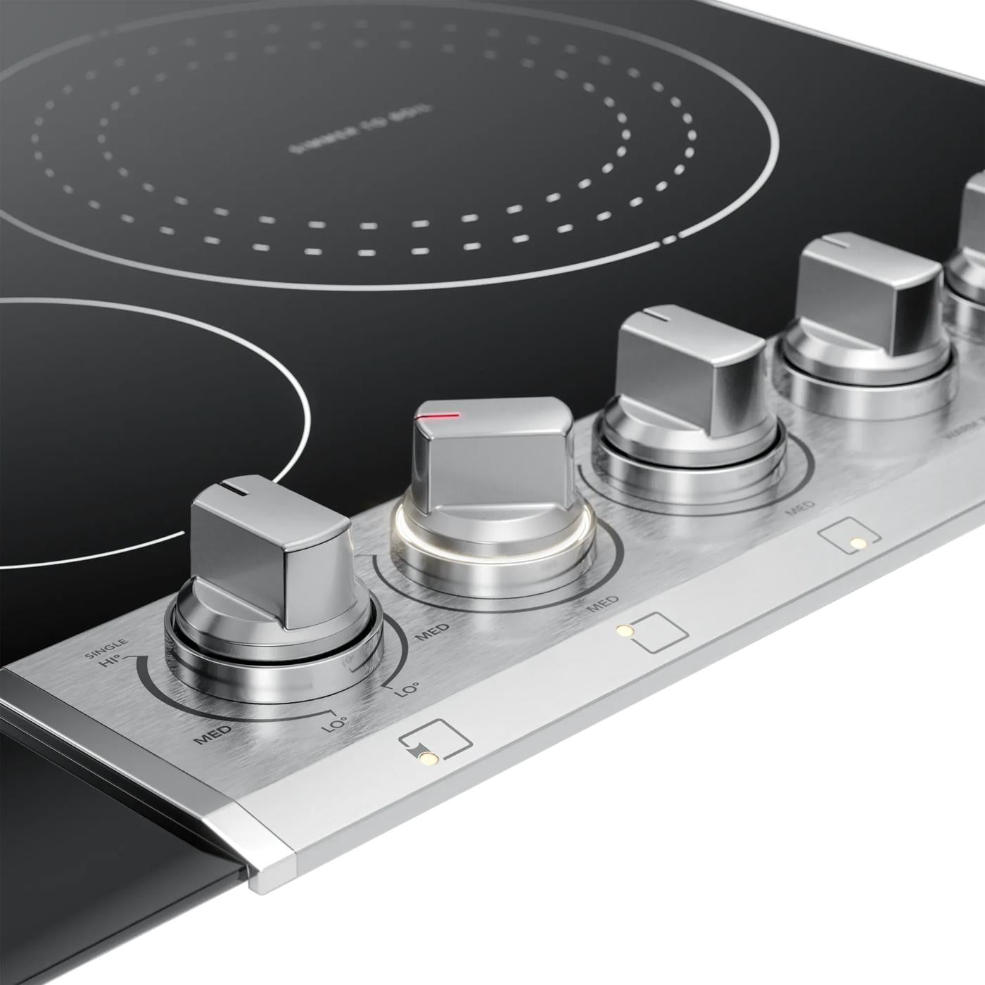 Close-up of stainless steel control knobs on a smooth black radiant electric cooktop from Cooktops collection