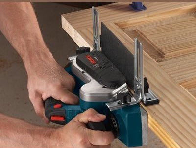 Electric handheld planer smoothing edges of wooden board for precision in woodworking and home improvement tasks