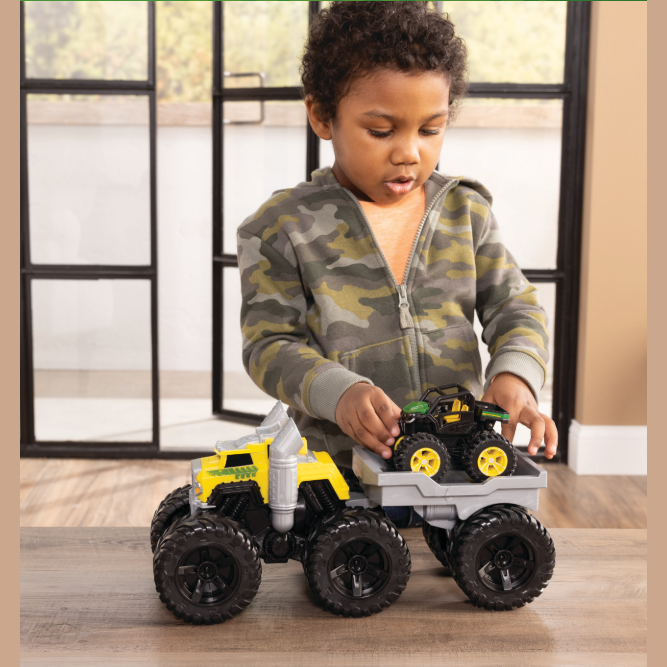 Young boy playing with a yellow and black toy semi truck and monster truck in Vehicles & Remote Controlled Toys collection