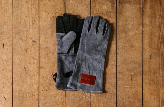 Pair of gray leather fire gloves with black reinforced palms for outdoor living and fire pits protection under $100 collection