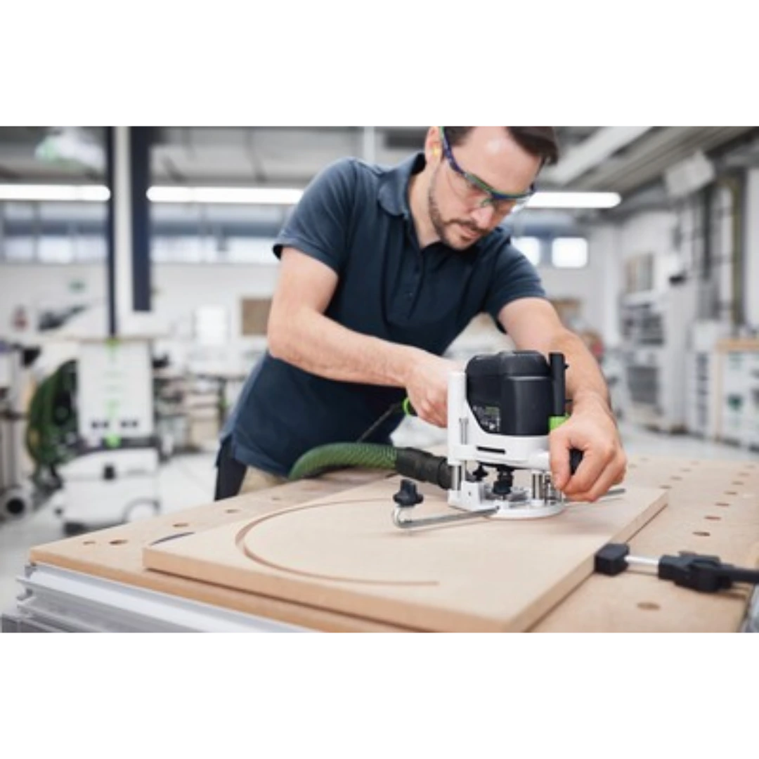 Man using a router with Festool trammel unit to cut precise circular patterns on wood in woodworking tool accessories collections
