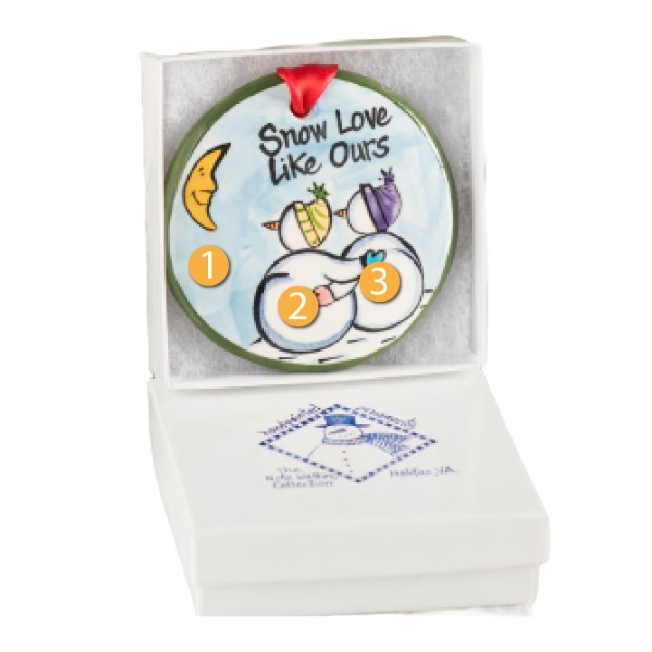 Hand-painted ceramic Christmas ornament with snowmen and "Snow Love Like Ours" text in gift box packaging