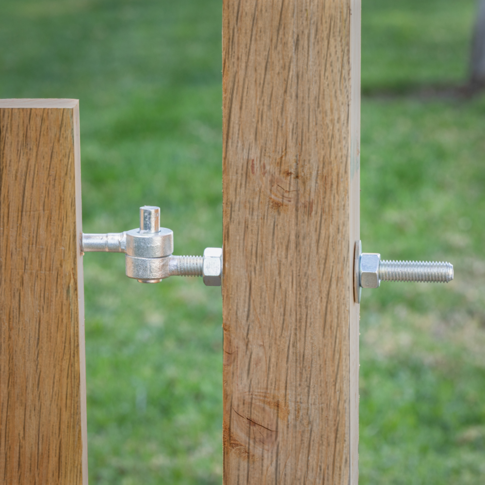 Zinc-plated adjustable bolt hook fastening two wooden gate panels for door and gate hardware in home improvement tools collection