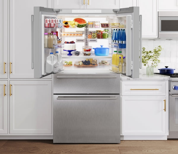 Open stainless steel French door bottom mount refrigerator with organized fresh food and beverage storage in kitchen setting