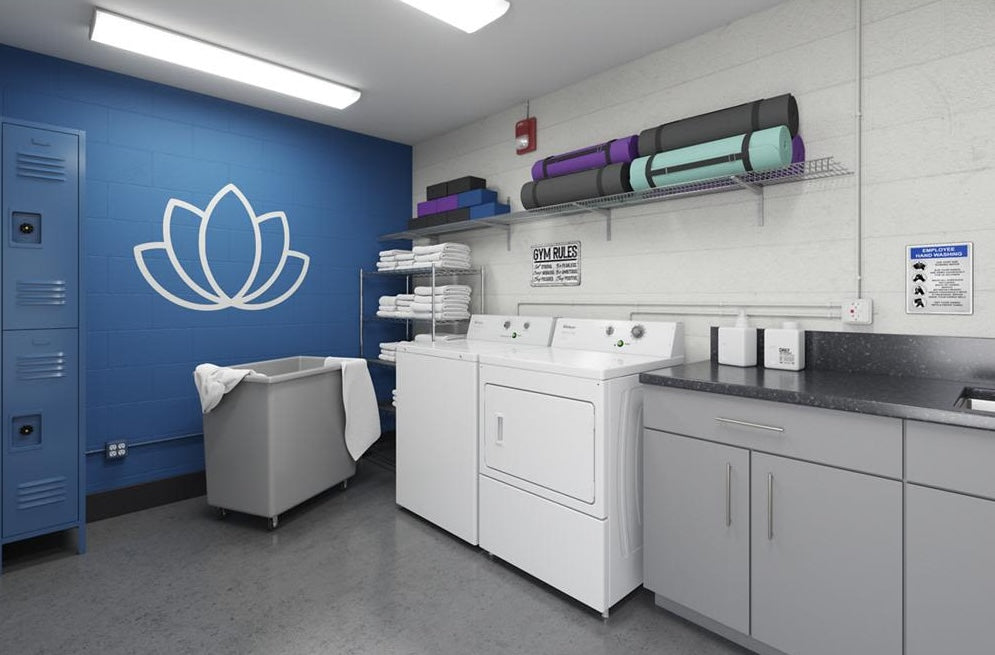 White heavy-duty dryer with matching washer in a clean laundry room equipped for tools and home improvement use