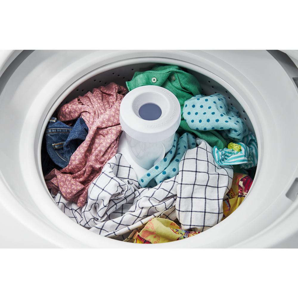 Top load washer filled with colorful laundry, showing a variety of fabrics inside as part of appliance laundry centers at Hartville Hardware.