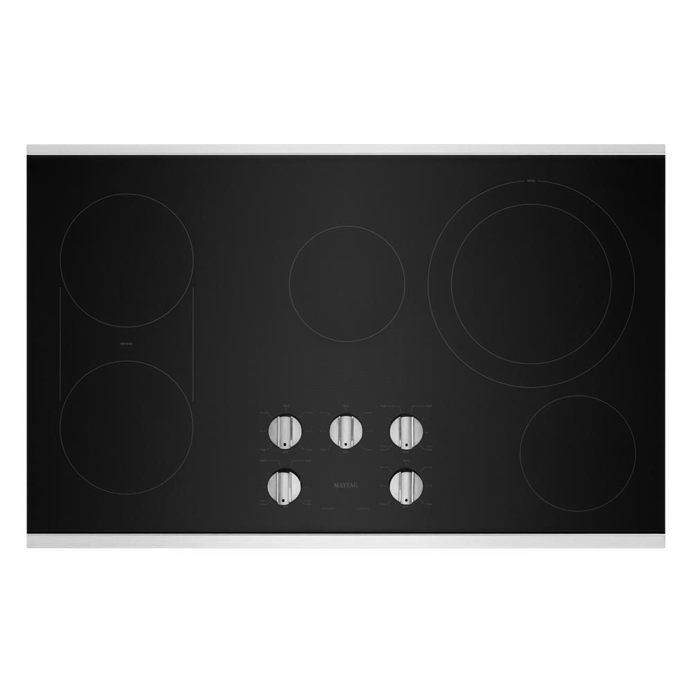 Black electric cooktop with five control knobs and multiple burner zones in kitchen appliances collections
