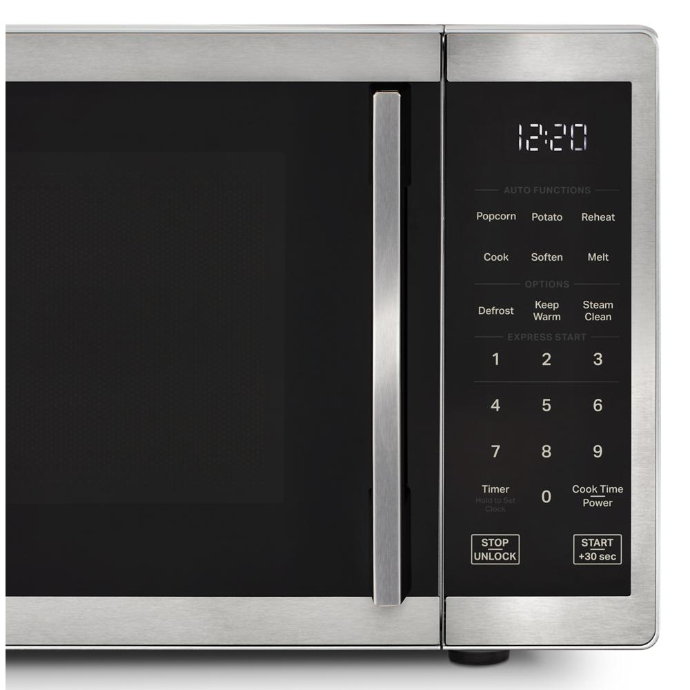 Stainless steel countertop microwave control panel with digital clock and multiple preset cooking functions in kitchenware collection
