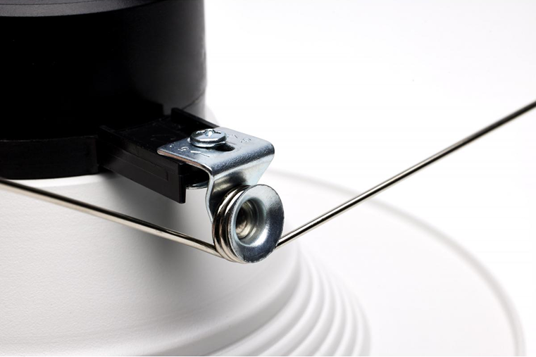 Close-up of metal spring clip and black adjustment tab on white LED retrofit downlight for home improvement lighting