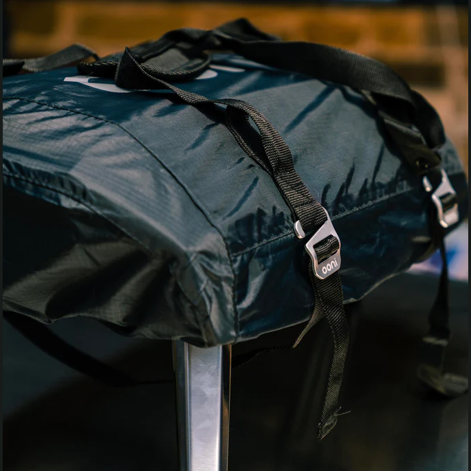 Black polyester carry cover with adjustable straps for outdoor pizza ovens in grill accessories and outdoor living collections