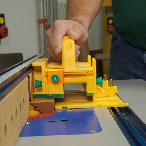 Yellow push block with grip handle and adjustable features for precise cutting in saw accessories and tool collections