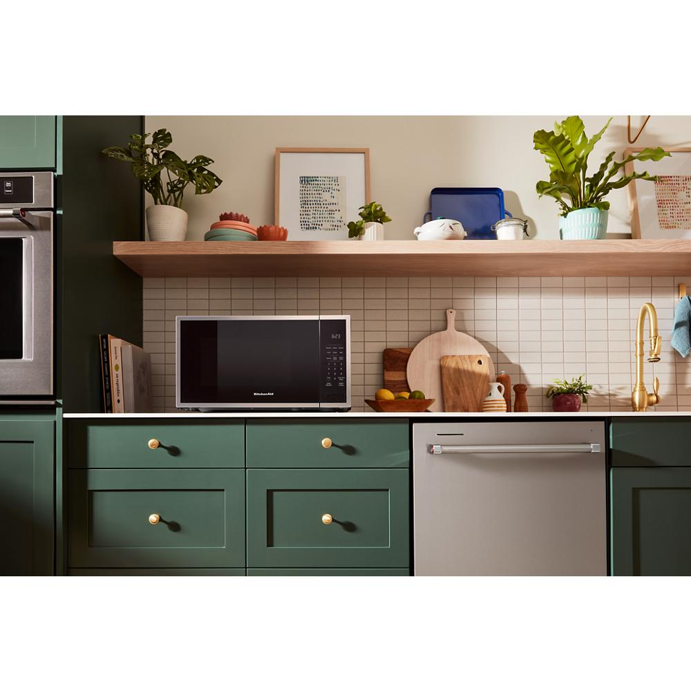 KitchenAid microwave on green kitchen cabinetry with wooden shelf and decorative plants in Kitchen & Kitchenware collections