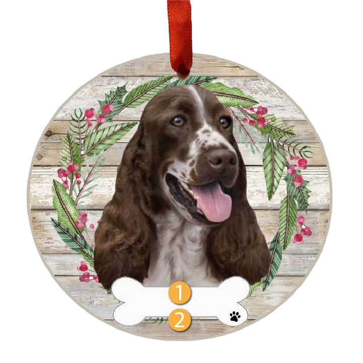 Round wooden Christmas ornament with Springer Spaniel face surrounded by festive wreath and red ribbon