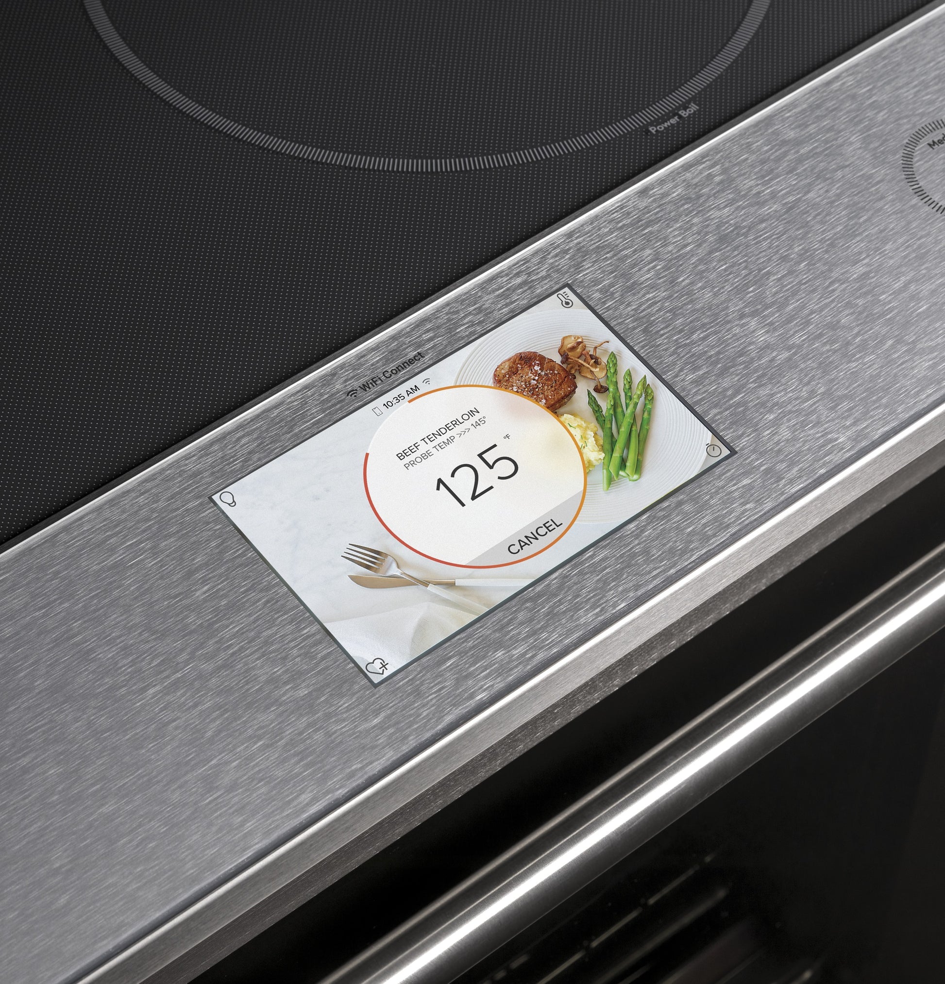 Digital touchscreen on stainless front-control induction and convection range showing beef tenderloin cooking timer at 125 degrees