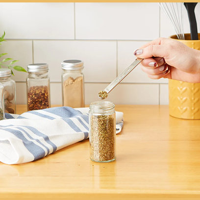 Polished stainless steel 1/8 teaspoon measuring spoon scooping spices in kitchenware and kitchen gadgets collection