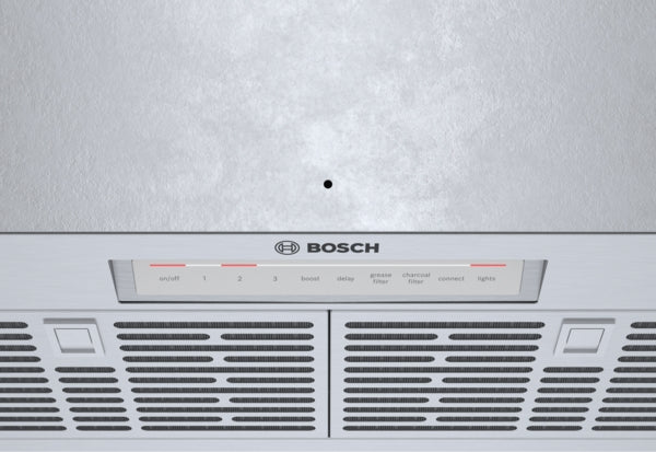 Close-up of stainless steel range hood vent with Bosch logo and control panel for kitchen appliances collection