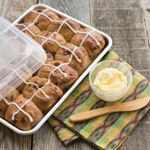 Natural aluminum baker’s quarter sheet with clear lid filled with cranberry scones on rustic wooden table, kitchenware under $50