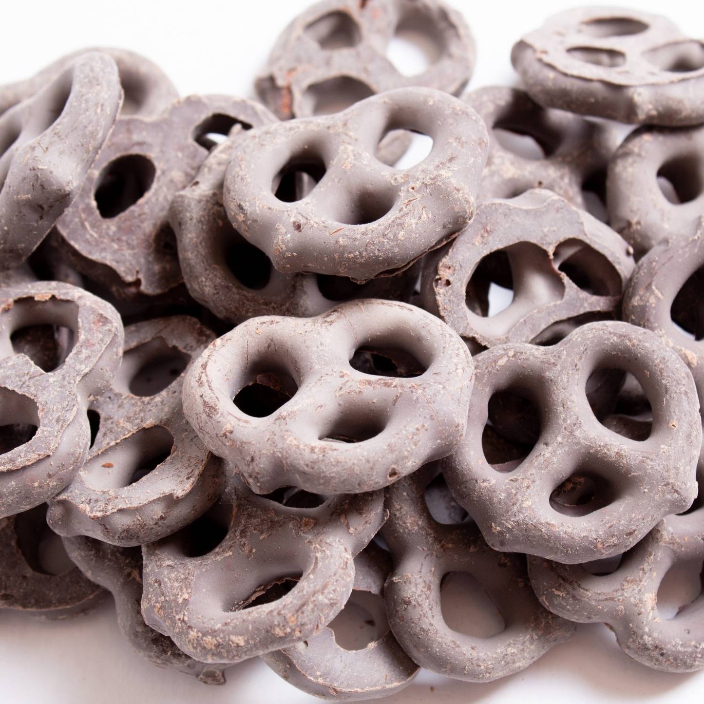 Close-up of mini pretzels coated in dark chocolate from Chips & Snacks and Food & Beverage under $50 collections