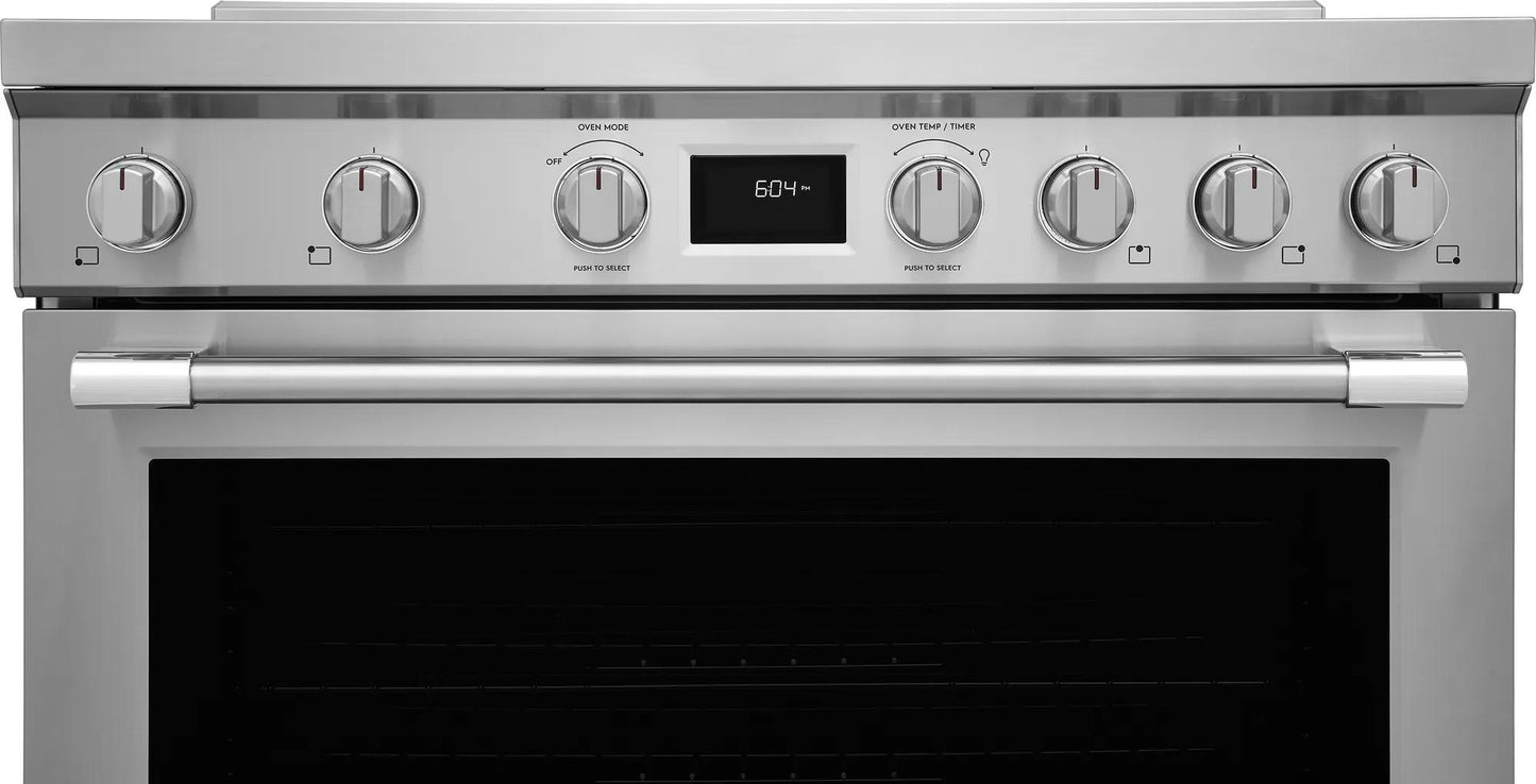 Stainless steel freestanding induction range with six control knobs and central digital display in kitchen appliances collection