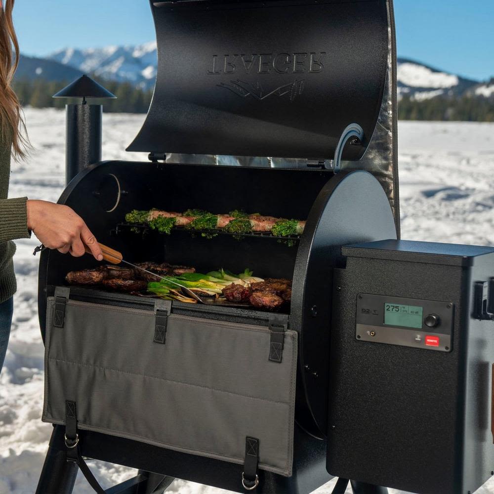 Gray insulated blanket attached to Traeger Pro Series grill for outdoor cooking and grilling accessories use