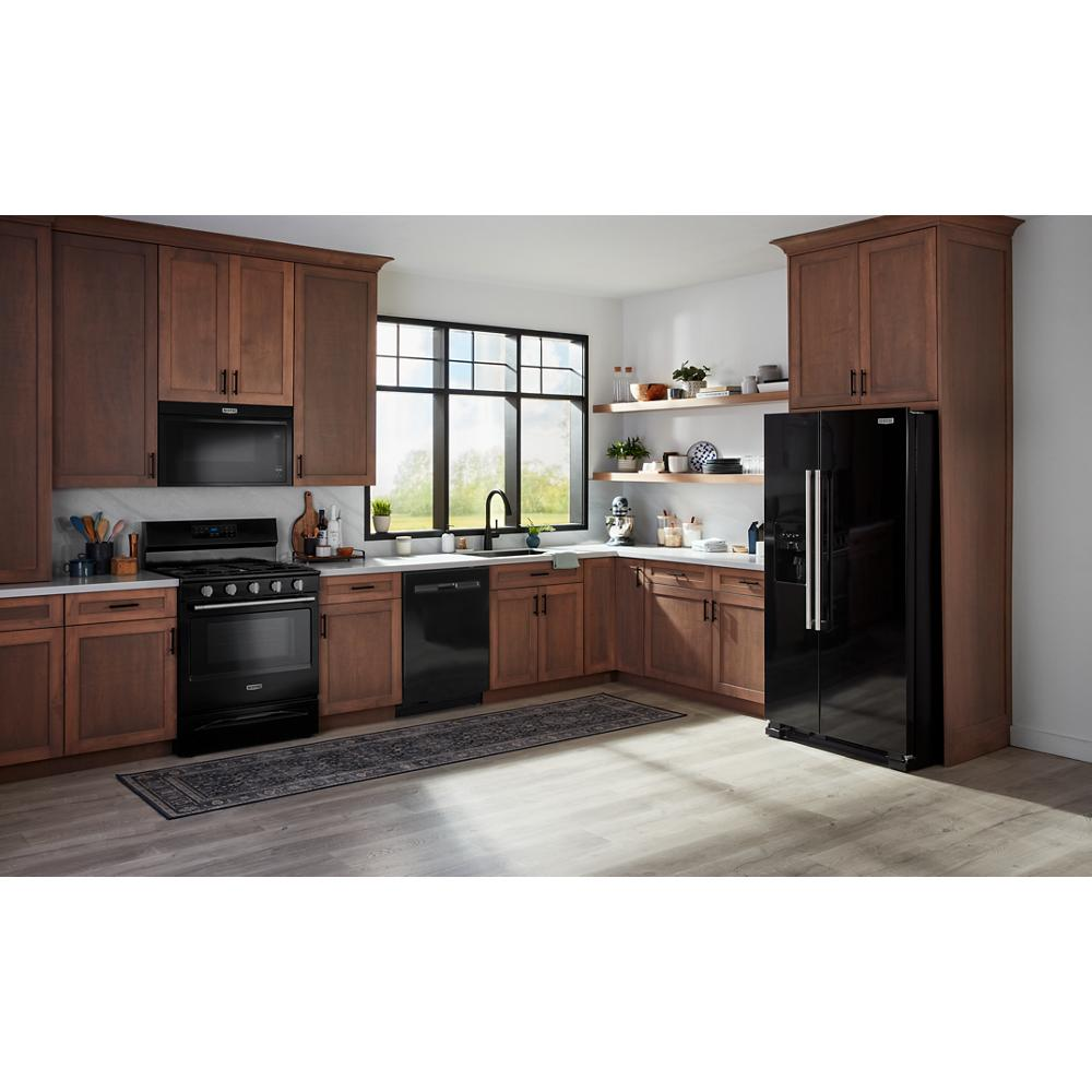Built-in black dishwasher with top controls integrated into wooden cabinetry in modern kitchen and appliances setting
