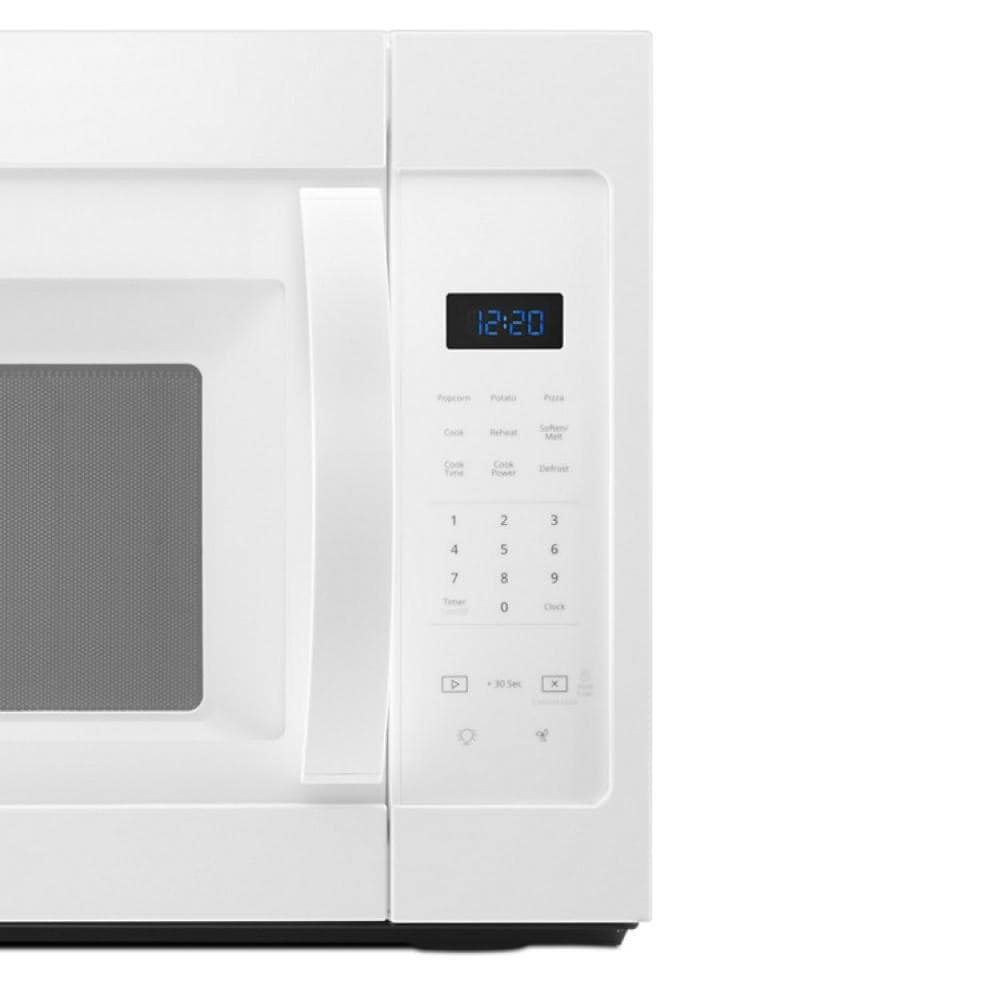 Close-up of white microwave control panel with digital clock and touchpad buttons in kitchen appliances collection