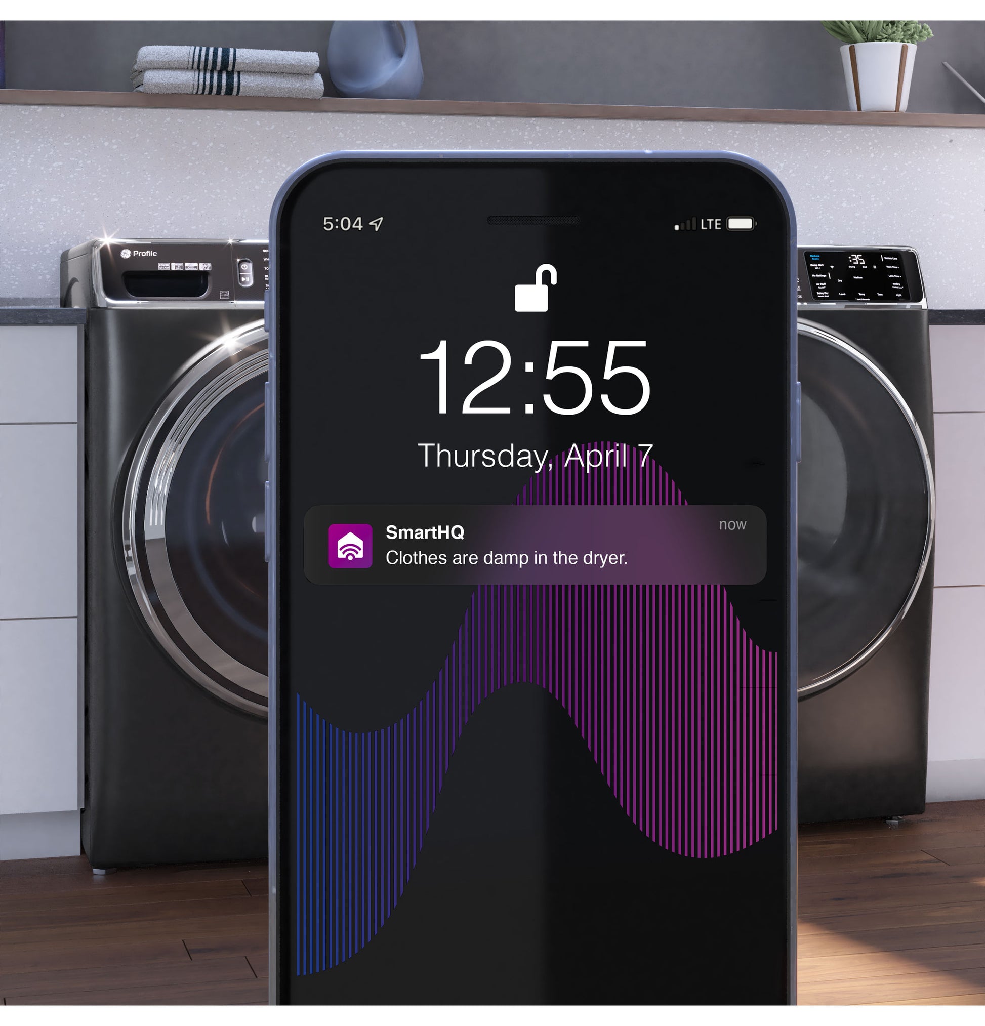 Smart notification on phone displaying damp clothes alert in front of dark green smart front load gas dryer in Appliances collection
