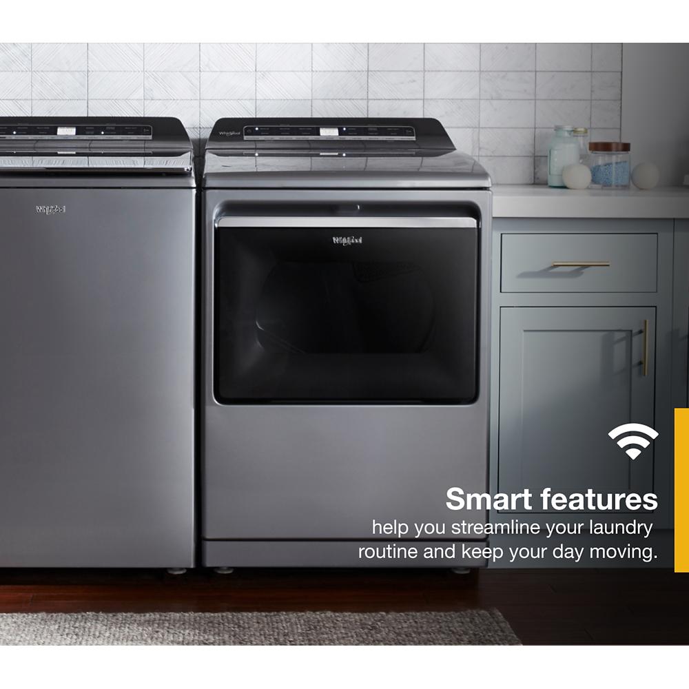 Dark gray top load gas dryer and matching washer with modern controls in a stylish laundry room setting