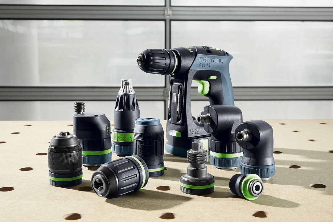 Festool cordless drill with multiple interchangeable attachments on perforated wood surface for woodworking tools