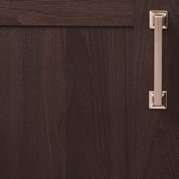 Satin nickel cabinet pull with squared ends mounted on dark wood cabinet in home improvement hardware collection