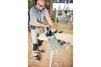 Man using Festool guide rail accessory set with power tool on woodworking bench in workshop environment