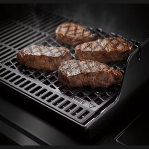 Cast iron dual-sided sear grate grilling four steaks for outdoor cooking and grilling accessories under $100
