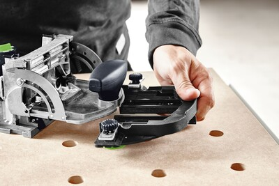 Hand positioning and adjusting a Festool 494847 Domino Handrail Fence for precise woodworking joinery in a workshop setting