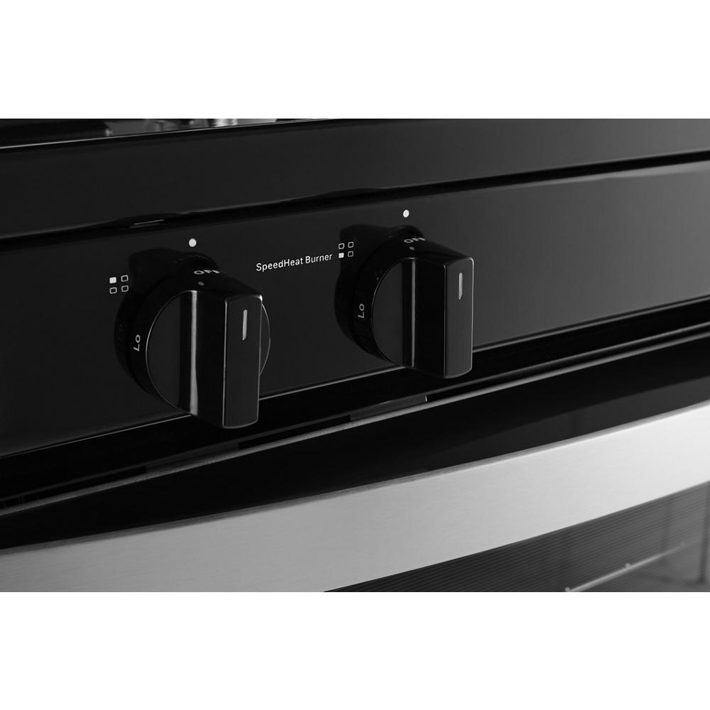 close-up of black control knobs on freestanding gas range with stainless steel trim for kitchen appliances