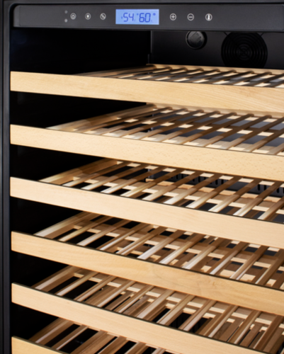 Interior of 24" wide wine cellar with wooden slatted shelves and digital temperature display from Appliances collection