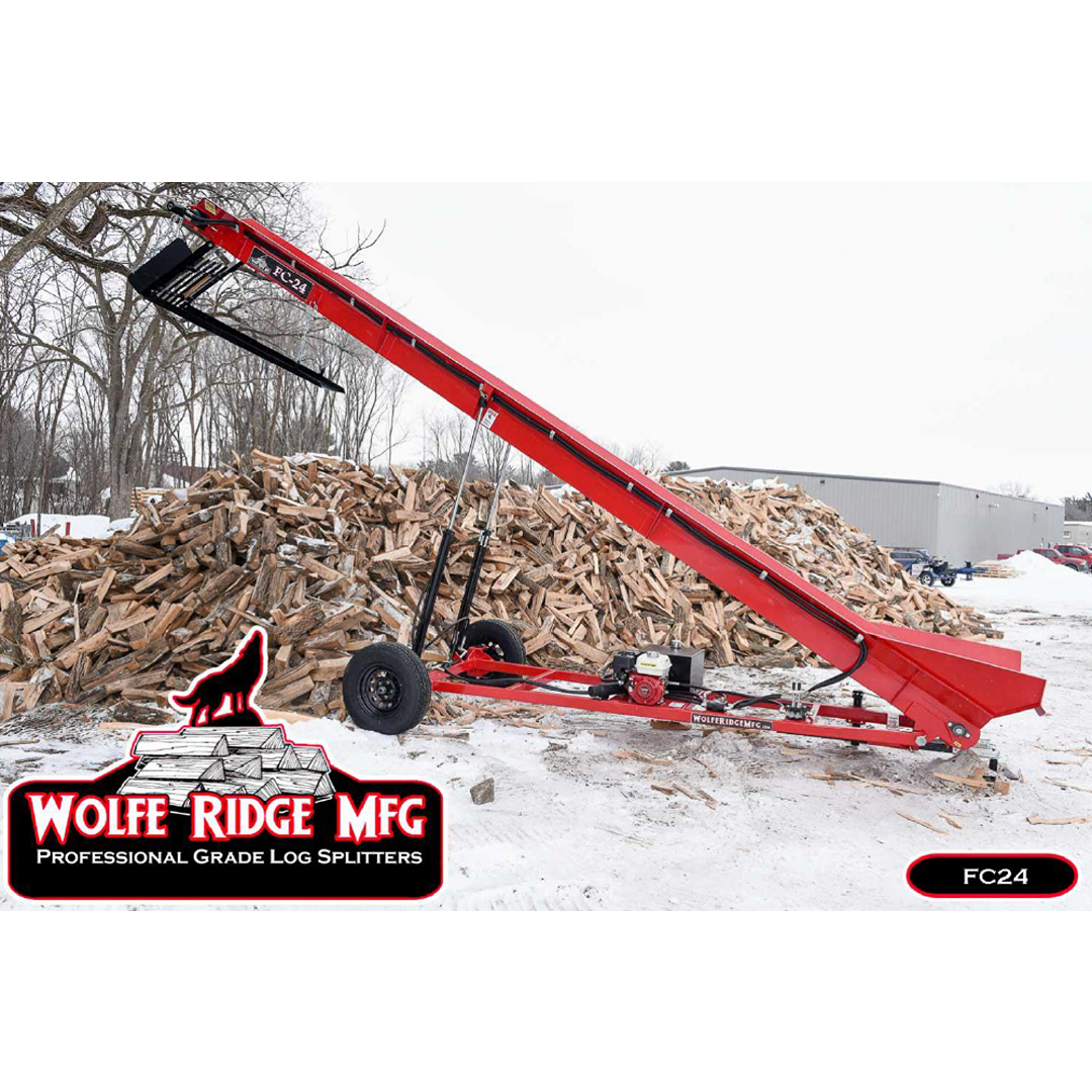 Red Wolfe Ridge firewood conveyor positioned outdoors on snowy ground near large stacked woodpile