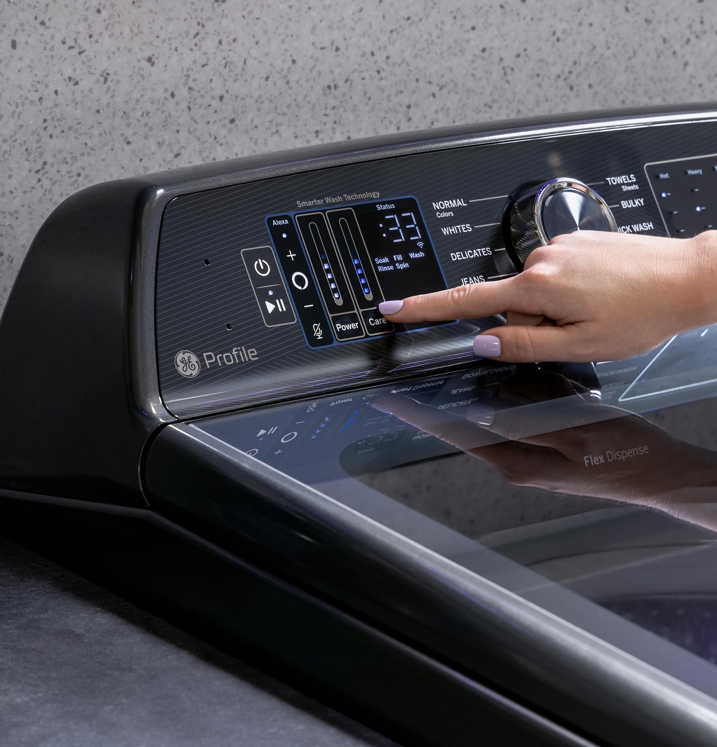 Person adjusting settings on black GE Profile washer control panel in modern laundry appliance setting